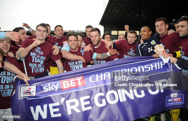 The Burnley team celebrates after they win promotion to the Premier League during the Sky Bet Championship match at Turf Moor, Burnley.