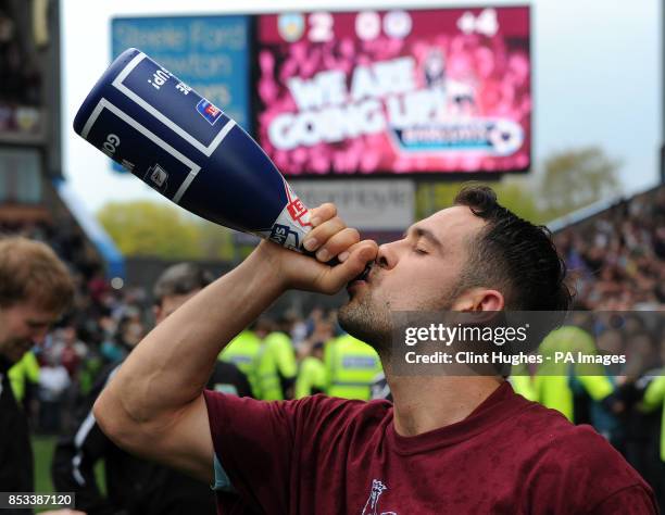 Burnley's Danny Ings celebrates with a bottle of champagne after his side win promotion to the Premier League during the Sky Bet Championship match...