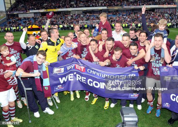The Burnley team celebrates after winning promotion to the Premier League during the Sky Bet Championship match at Turf Moor, Burnley.