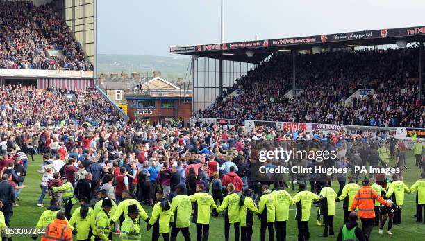 Burnley's fans celebrate by invading the pitch after their side win promotion to the Premier League during the Sky Bet Championship match at Turf...