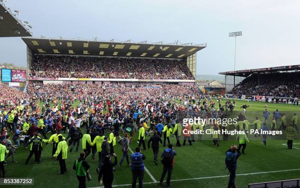 Burnley's fans celebrate by invading the pitch after their side win promotion to the Premier League during the Sky Bet Championship match at Turf...