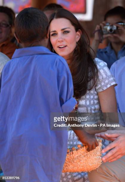 The Duke and Duchess of Cambridge receive gifts during a 'Welcome to Country' display at Uluru-Kata Tjuta Cultural Centre, Uluru, during the...