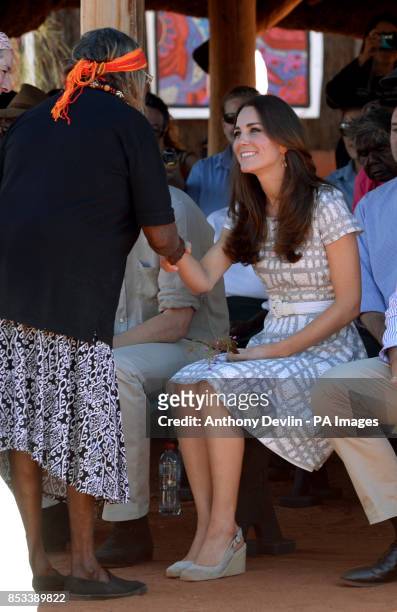The Duchess of Cambridge receives a necklace as the Duke and Duchess of Cambridge view a 'Welcome to Country' display at Uluru-Kata Tjuta Cultural...