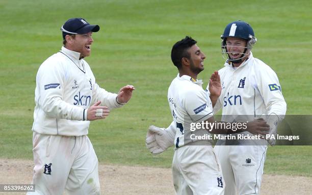 Warwickshire's Ateeq Javid celebrates taking the wicket of Lancashire batsman Jos Buttler with Ian Bell , during the LV County Championship, Division...