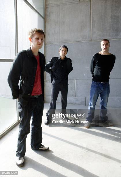 Photo of Chris WOLSTENHOLME and MUSE and Dominic HOWARD and Matt BELLAMY; L-R: Dominic Howard, Matt Bellamy, Chris Wolstenholme - posed, group shot