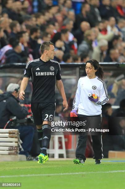 Chelsea's John Terry walks off the pitch after sustaining a foot injury, with Physiotherapist Eva Carneiro