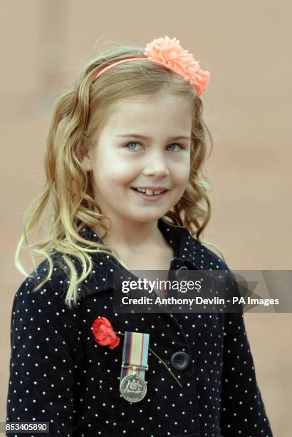 Young girl wearing medals participates in a parade as the Duke and Duchess of Cambridge attend the ANZAC March and Commemorative Service and lay a...