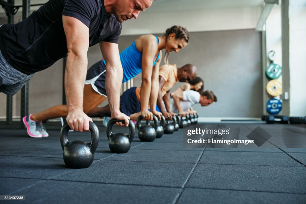 People doing pushups together in a health club class