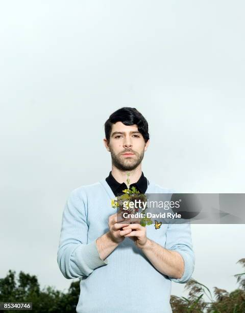 Photo of FOALS and Yannis PHILIPPAKIS; Posed portrait of Yannis Philippakis, flowers