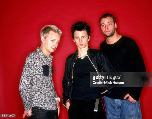Photo of Chris WOLSTENHOLME and Matt BELLAMY and Dominic HOWARD and MUSE; L-R: Dominic Howard, Matt Bellamy, Chris Wolstenholme - posed, studio