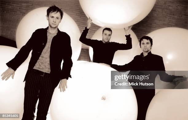 Photo of Chris WOLSTENHOLME and MUSE and Dominic HOWARD and Matt BELLAMY; L-R: Dominic Howard, Chris Wolstenholme, Matt Bellamy - posed, group shot