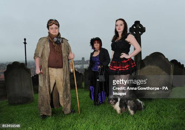 Left to right. Rhys Thomas-Lindsay, Jane Thomas, Rhian Thomas-Lindsay and their dog Zelda stand in the grounds of St Mary's Church, Whitby, during...