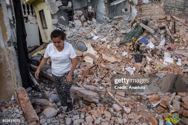 Woman walks on rubble of her house, 5 days after a 7.1 earthquake in Jojutla, Morelos state, Mexico on September 24, 2017.