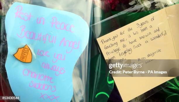 Flowers are left outside Corpus Christi Catholic College in Leeds, after much loved teacher Ann Maguire was stabbed to death yesterday in front of...