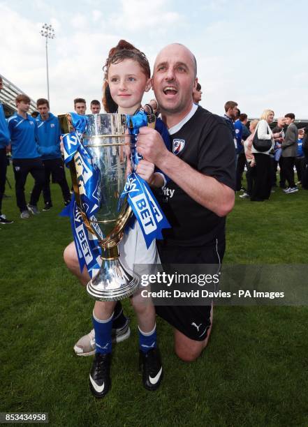 Chesterfield manager Paul Cook celebrates with his son Conor after winning the Sky Bet League Two at the Proact Stadium, Chesterfield.