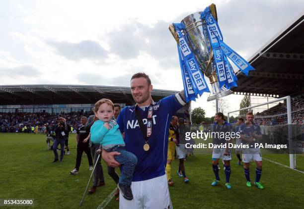 Chestefield's Ian Evatt celebrates winning the Sky Bet League Two with the trophy at the Proact Stadium, Chesterfield.