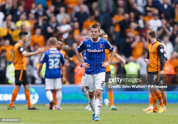 Carlisle United's captain James Berrett stands dejected at the end of the match as his side are relegated during the Sky Bet League One match at...