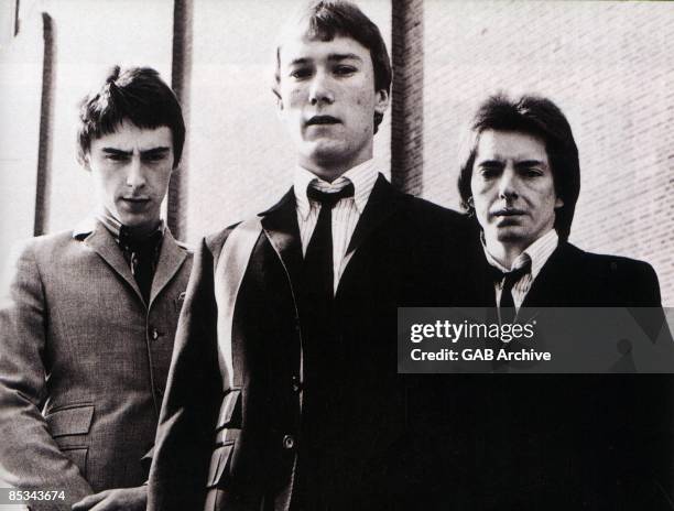 Photo of JAM and Paul WELLER and Rick BUCKLER and Bruce FOXTON, L-R: Paul Weller, Rick Buckler, Bruce Foxton - posed, group shot, on set of News Of...