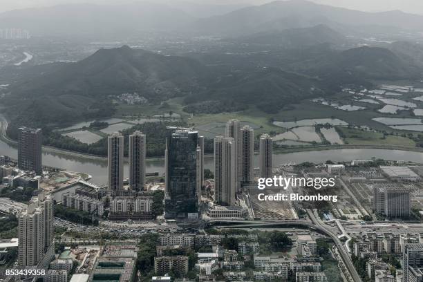 The Sham Chun river marking the border between residential and commercial buildings in mainland China, foreground, and farmland in Hong Kong is seen...