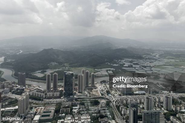 The Sham Chun river marking the border between residential and commercial buildings in mainland China, foreground, and farmland in Hong Kong is seen...