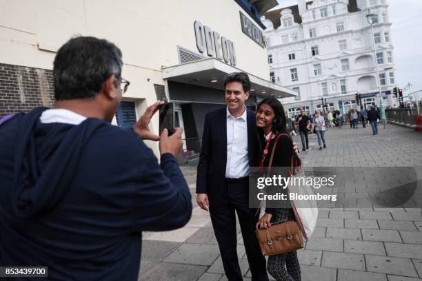 Ed Miliband, former leader of the U.K. Opposition Labour Party, poses for a photograph with an attendee on the first day of the party's annual...