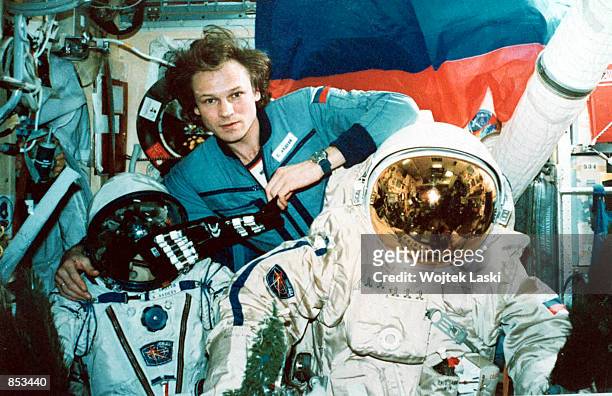 Russian cosmonaut Serguei Avdeyev, center, poses for a photo December 31, 1995 aboard the Mir space station with his space suited colleagues Yuri...