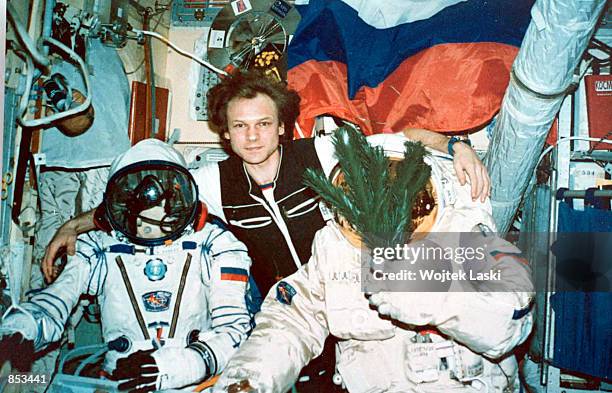 Russian cosmonaut Serguei Avdeyev, center, poses for a photo December 31, 1995 aboard the Mir space station with his space suited colleagues Yuri...