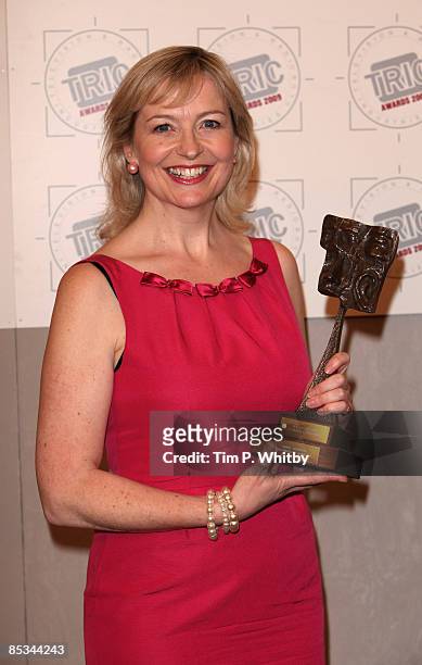Carol Kirkwood poses with award for 'best TV weather presenter' in front of the winners boards at Television and Radio Industries Club awards held at...