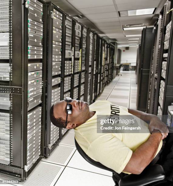 sleeping security guard in server room - security guard sleeping stock pictures, royalty-free photos & images