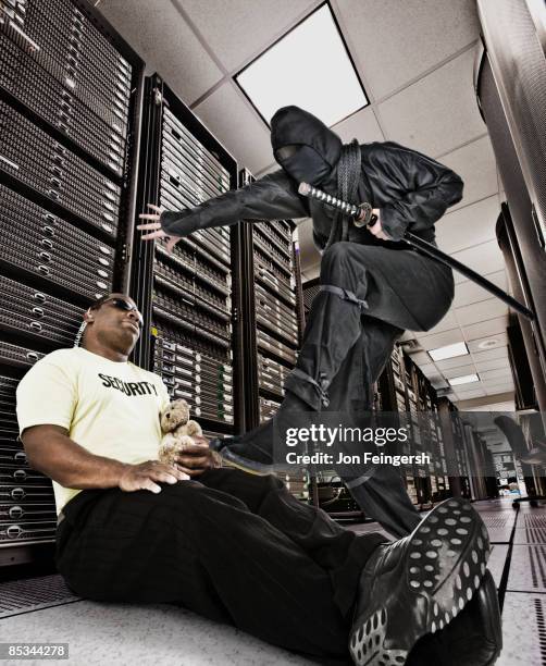 ninja stepping over sleeping security guard - security guard sleeping stock pictures, royalty-free photos & images