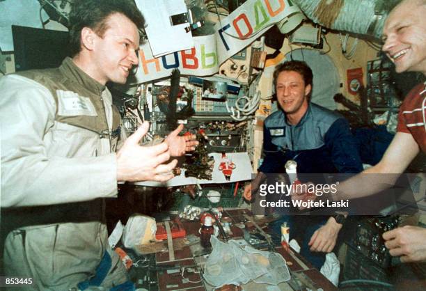 In this undated file photo, Mir Crew members Yuri Gidzenko, left, Thomas Reiter, center, and Serguei Avdeyev celebrate New Year 1996 aboard the...