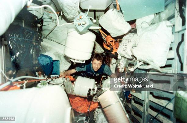 In this file photo from 1996, German astronaut Thomas Reiter receives a shipment of food and material from the cargo spaceship "Progress" aboard the...
