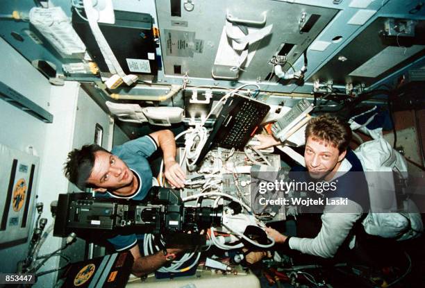 In this undated file photo, Mir Crew commander Yuri Gidzenko, left, and German astronaut Thomas Reiter conduct an experiment on breathing in space...