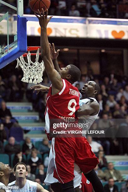 EclipseJet Amsterdam's Dutch Victor Thomas vies with Mons' US Kelvin Torbert during their Eurochallenge basketball match on March 10 in Mons. AFP...