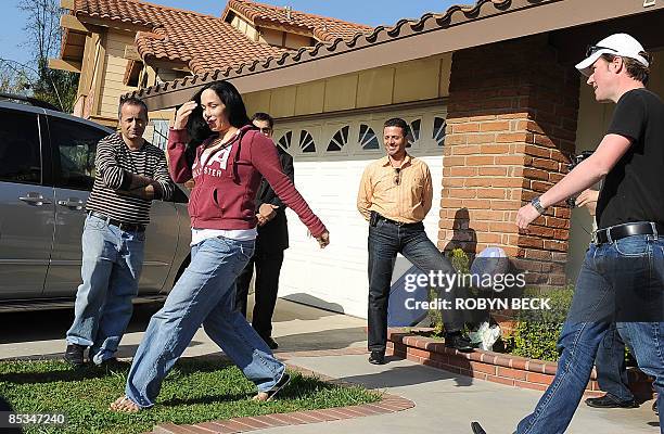 Nadya Suleman, the mother of octuplets born earlier this year, walks outside her new house for a video crew in La Habra, California, 10 March 2009....