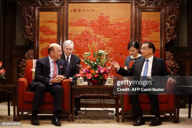 Secretary of Commerce Wilbur Ross speaks with Chinese Premier Li Keqiang during their meeting at the Zhongnanhai state guesthouse in Beijing on...