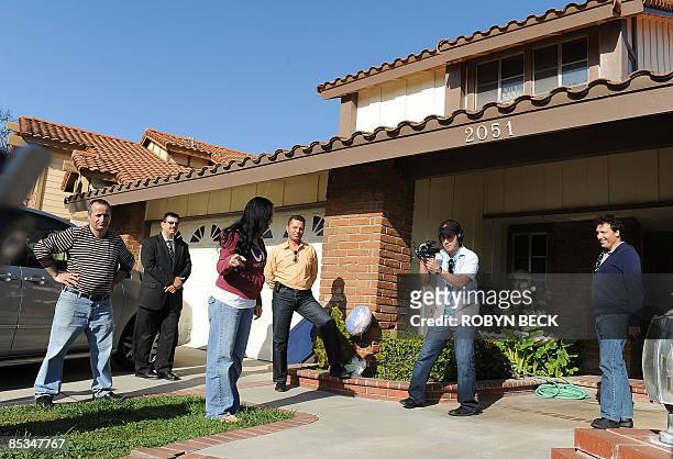 Nadya Suleman, the mother of octuplets born earlier this year, talks outside her new house for a video crew in La Habra, California, 10 March 2009....