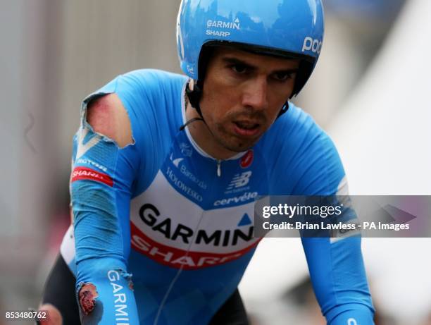 An injured Garmin Sharp team member crosses the line after losing a number of team members to a crash during the Team Time Trial of the 2014 Giro...