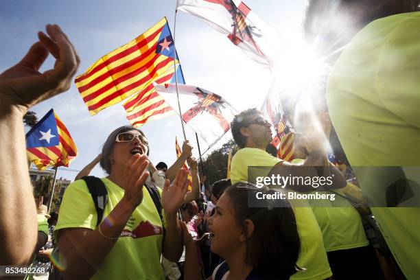 Supporters of Catalan independence wave flags and shout slogans during a demonstration called for by the Catalan National Assembly and Omnium...