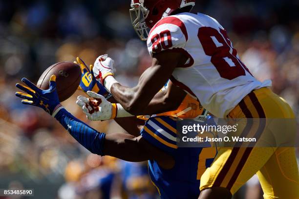 Cornerback Josh Drayden of the California Golden Bears intercepts a pass intended for wide receiver Deontay Burnett of the USC Trojans during the...