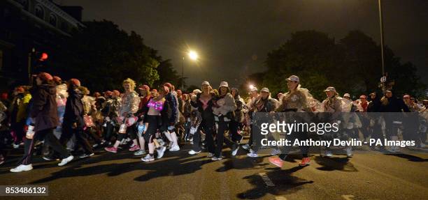 Entrants participate in The MoonWalk London 2014 as over 17,000 women and men wearing brightly decorated bras power walk through the streets of...