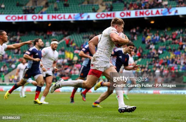 England's Phil Burgess scores a try against France during day two of the Marriott London Sevens at Twickenham Stadium, London.