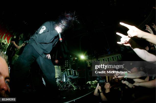 Photo of Mick THOMSON and Corey TAYLOR and SLIPKNOT; Mick Thomson Corey Taylor performing on stage, audience hands, video camera