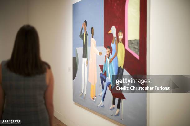 Member of staff poses for the media next to Le Rodeur: The Exchange 2016 by artist Lubaina Himid during a press preview for the 2017 Turner Prize at...