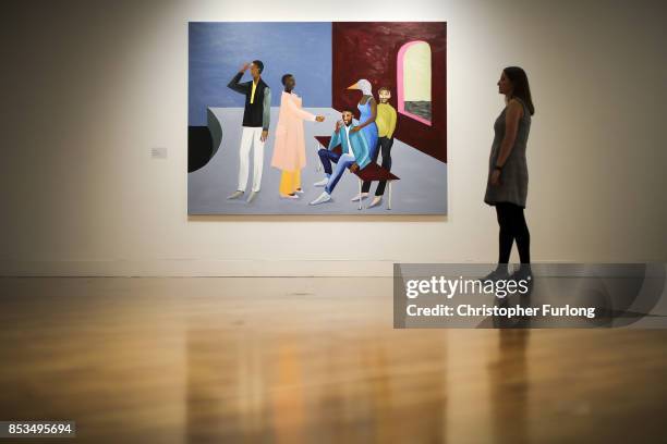 Member of staff poses for the media next to Le Rodeur: The Exchange 2016 by artist Lubaina Himid during a press preview for the 2017 Turner Prize at...