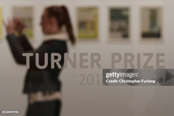Woman photographs installations during a press preview for the 2017 Turner Prize at The Ferens Art Gallery on September 25, 2017 in Hull, England. An...
