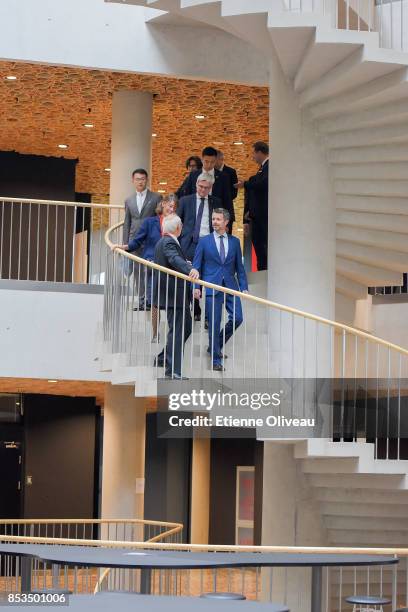 Crown Prince Frederik of Denmark walks down a spiral staircase while he tours the new SDC-building on September 25, 2017 at the Yanqi Lake, Beijing,...