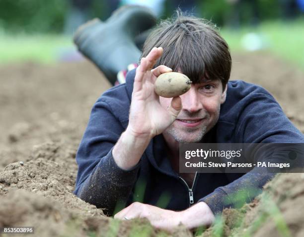 Alex James is helped planting potatoes by children from Kingham and Bledington Primary Schools at his farm near Kingham, Oxfordshire. The potatoes...