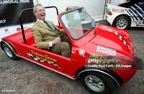 Leader Nigel Farage tries out a converted mini, at the start of the annual Balmoral show, outside Belfast, during a one day visit to the province.