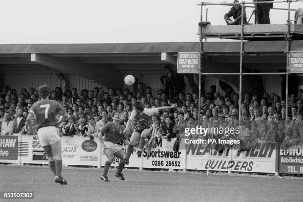 England's Kenny Sansom keeps his eye on the ball, as Aylesbury United's Brendan Phillips jumps for the header during the warm-up game before the...